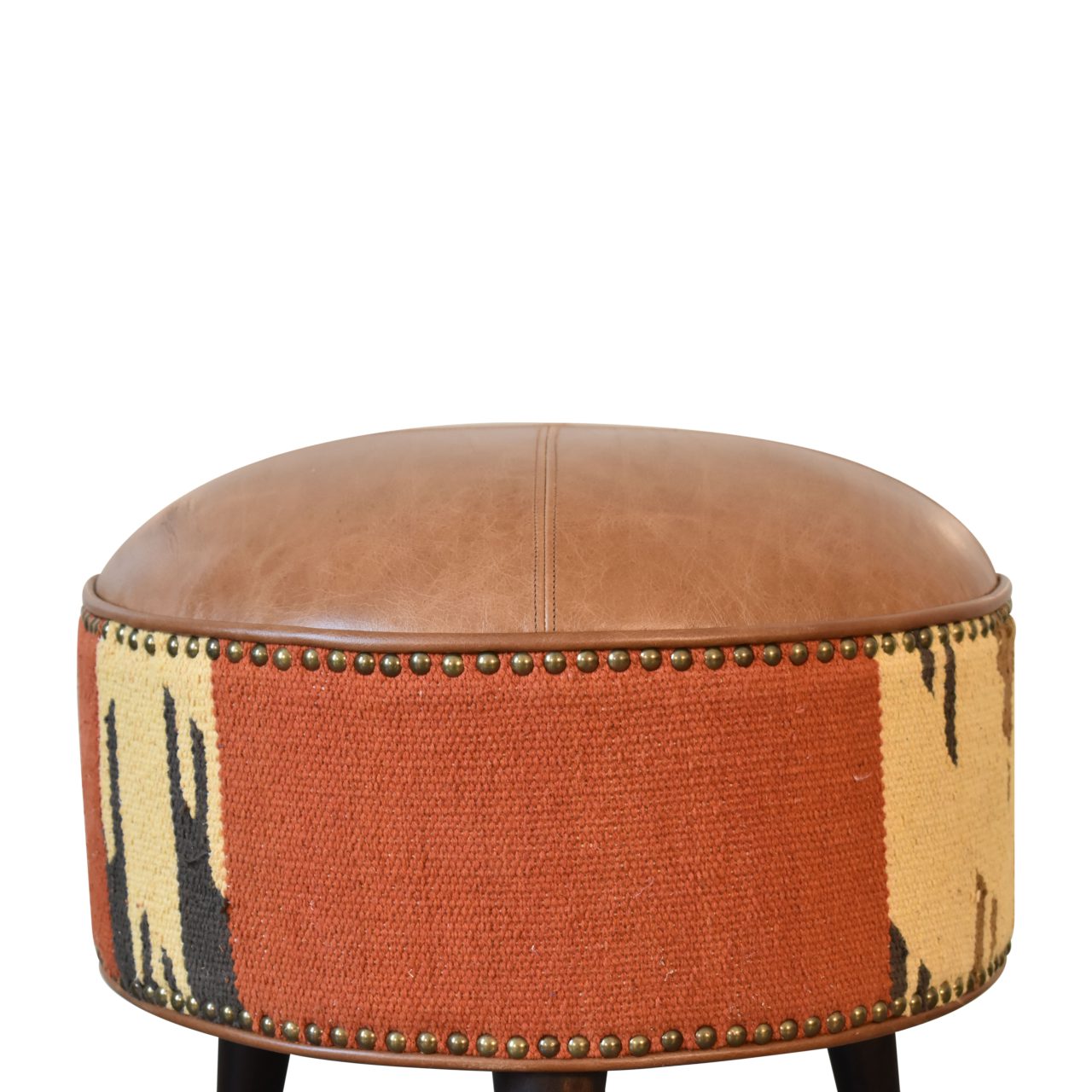 Durrie & Leather Mixed Footstool with Nordic-style legs, buffalo leather, and durrie print. close up view of print.