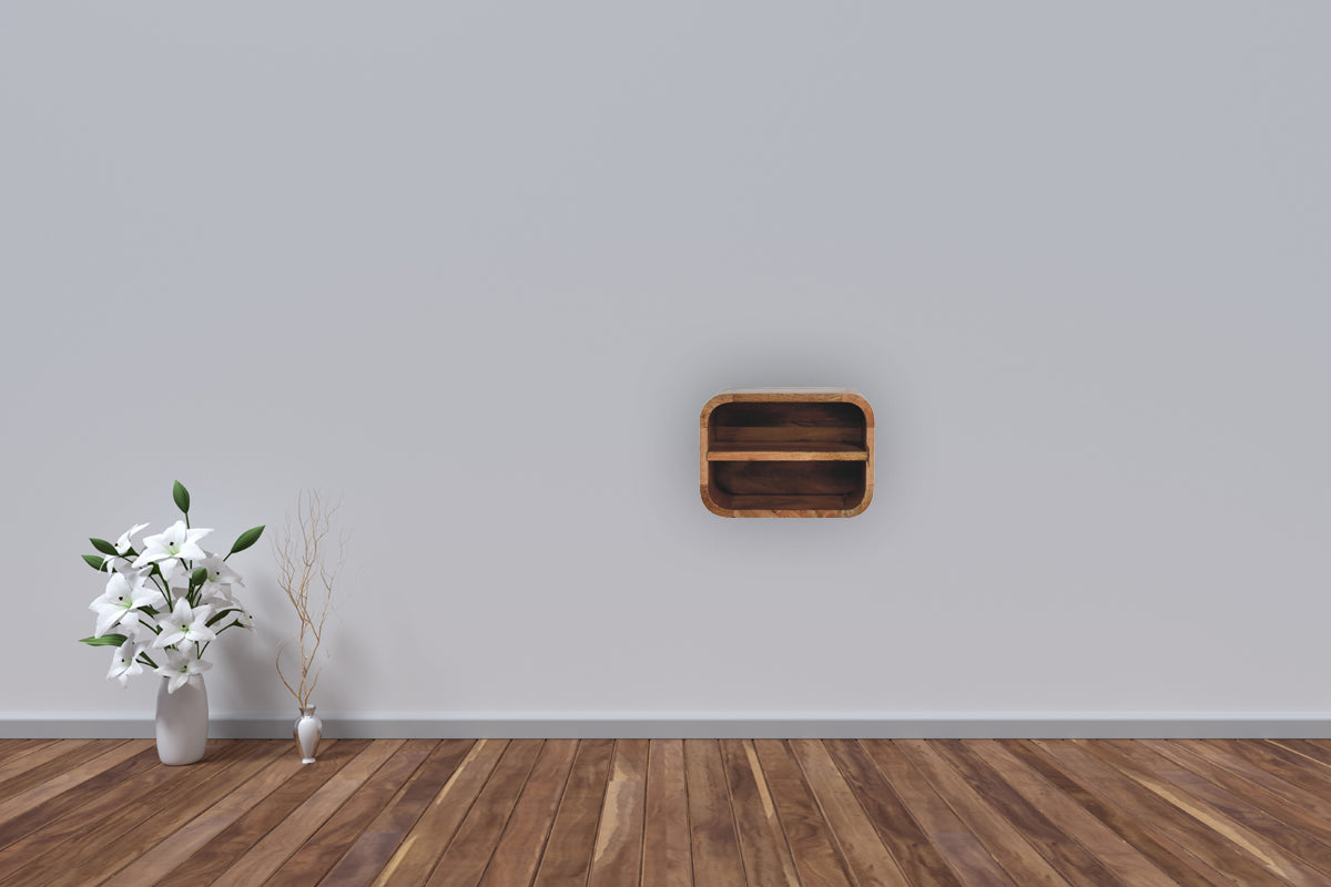 Oak-ish floating open curve nightstand with 2 open shelves. Wall-mounted  and solid mango wood. Mounted on the wall in a living space.