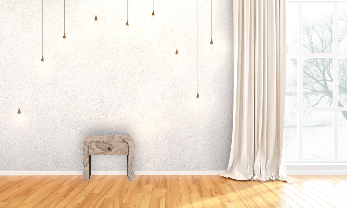 Nouveau nightstand with marble effect veneer, solid mango wood frame, and brass round knob. Full view in a living space.