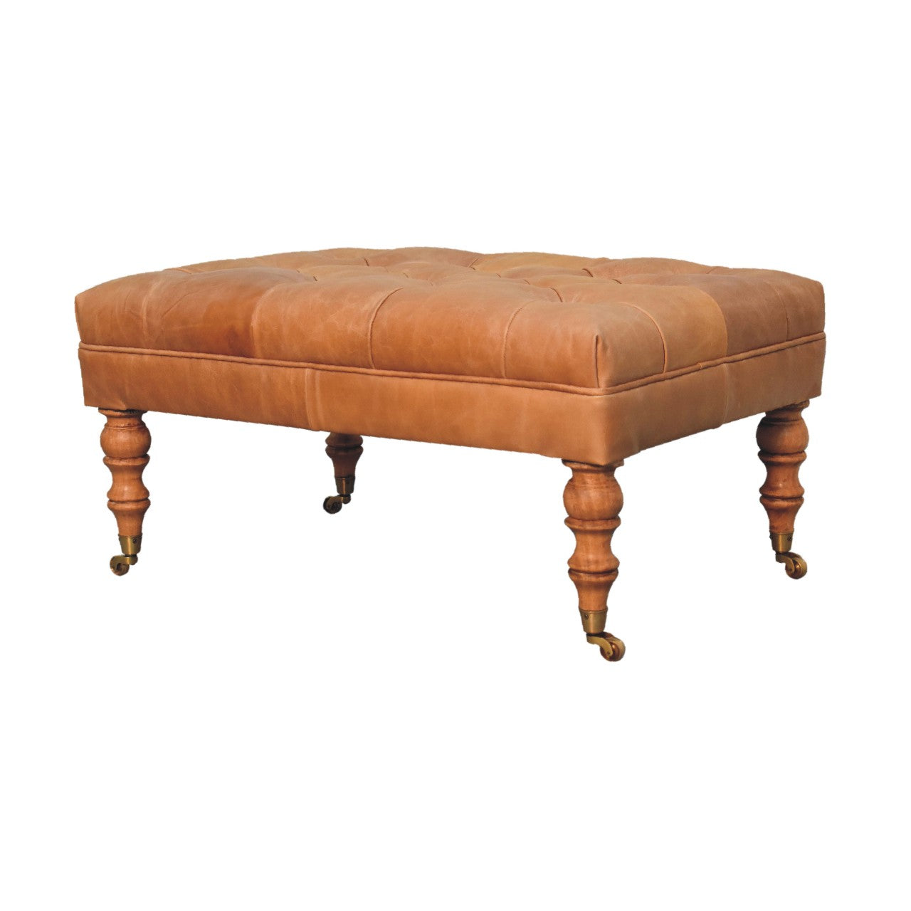 Tan buffalo leather ottoman with solid mango wood base, deep-buttoned top, and light walnut hand-turned feet. Edge view