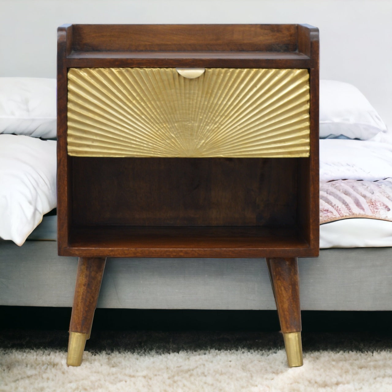 Manila Gold Chestnut Nightstand with brass plated drawer, open slot, and Nordic style legs. Full view by a bedside