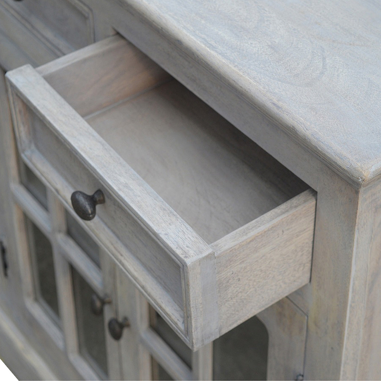 Stone Acid Wash Glazed Sideboard made from solid mango wood with four drawers and four glazed doors. Opened drawer view